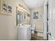 Bathroom with vanity, sink, a large mirror, and a toilet with wood look flooring at 6001-7035 S Kings Hwy., Myrtle Beach, SC 29575