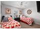 Bedroom featuring twin beds, ceiling fan, and nautical decor on the walls at 6001-7035 S Kings Hwy., Myrtle Beach, SC 29575