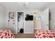 Bedroom with an open closet, twin beds, and a TV on the wall at 6001-7035 S Kings Hwy., Myrtle Beach, SC 29575