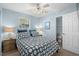 Charming bedroom with ensuite bathroom, ceiling fan, and inviting patterned bedding at 6001-7035 S Kings Hwy., Myrtle Beach, SC 29575