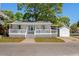 Charming one-story house with white siding, covered porch, and vibrant landscaping at 6001-7035 S Kings Hwy., Myrtle Beach, SC 29575