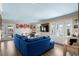 Bright living room with blue sectional sofa, beach-house decor, and a seamless indoor-outdoor flow at 6001-7035 S Kings Hwy., Myrtle Beach, SC 29575