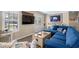 Cozy living room featuring a comfortable blue sectional sofa and stylish beach-themed decor at 6001-7035 S Kings Hwy., Myrtle Beach, SC 29575
