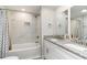 Modern bathroom featuring double sinks, granite counters, white cabinets, and a marble-tiled shower at 6001-Mh409 S Kings Hwy., Myrtle Beach, SC 29575