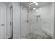 Modern tiled shower featuring glass door, mosaic floor, shower seat, and brushed nickel hardware at 6001-Mh409 S Kings Hwy., Myrtle Beach, SC 29575