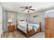 Charming bedroom with hardwood flooring, ceiling fan, and classic wooden furniture at 6001-Mh409 S Kings Hwy., Myrtle Beach, SC 29575