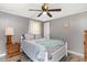 Cozy bedroom with gray walls, hardwood flooring, ceiling fan, and a comfortable white bed at 6001-Mh409 S Kings Hwy., Myrtle Beach, SC 29575