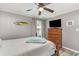 Bedroom with hardwood floors, flat-screen TV, and classic wooden furniture at 6001-Mh409 S Kings Hwy., Myrtle Beach, SC 29575