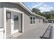 Side of home showcases well-maintained gray siding, white trim, and an inviting entrance at 6001-Mh409 S Kings Hwy., Myrtle Beach, SC 29575