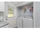 Bright laundry area adjacent to the kitchen, with a washer, dryer, and shelving at 6001-Mh409 S Kings Hwy., Myrtle Beach, SC 29575