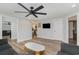Bright living room with sleek fan, tv, and open doorways to the dining and kitchen area at 6001-Mh409 S Kings Hwy., Myrtle Beach, SC 29575