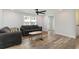 Bright living room features stylish wood-look flooring, modern ceiling fan, and neutral decor at 6001-Mh409 S Kings Hwy., Myrtle Beach, SC 29575