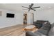 Spacious living room with sleek ceiling fan, tv, and an open doorway to the Primary bedroom at 6001-Mh409 S Kings Hwy., Myrtle Beach, SC 29575
