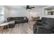 Open-concept living room featuring hardwood floors, gray sectional sofa, and a view into the dining area at 6001-Mh409 S Kings Hwy., Myrtle Beach, SC 29575
