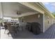Covered outdoor patio with ceiling fan, grill, and multiple seating areas for relaxing at 6001-Mh409 S Kings Hwy., Myrtle Beach, SC 29575