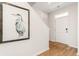 Inviting entryway featuring light walls, hard wood floors, artwork, and a white front door with a transom window at 718 Chazen Way, Longs, SC 29568