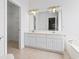 Well-lit bathroom featuring double sinks, a large mirror, a walk-in closet, and a bathtub at 736 Lalton Dr., Conway, SC 29526