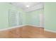 Bedroom with light green walls, vaulted ceiling, hardwood floors, and white curtains at 736 Lalton Dr., Conway, SC 29526