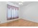 Bedroom with hardwood floors, a ceiling fan, and a large window with sheer curtains at 736 Lalton Dr., Conway, SC 29526