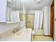 Cozy bathroom featuring a single sink vanity, toilet, and bathtub with a shower and white curtain at 742 Tall Oaks Ct., Myrtle Beach, SC 29588