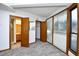Bedroom with neutral walls, plush carpet, large windows, and access to the ensuite bathroom and closet at 742 Tall Oaks Ct., Myrtle Beach, SC 29588
