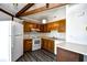 Kitchen with wood cabinets, white appliances, and eat-in counter at 742 Tall Oaks Ct., Myrtle Beach, SC 29588