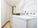 This laundry room includes a washer, dryer, shelving, and a utility sink at 742 Tall Oaks Ct., Myrtle Beach, SC 29588