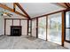 Cozy living room featuring a fireplace, vaulted ceiling, and large windows at 742 Tall Oaks Ct., Myrtle Beach, SC 29588