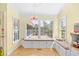 Inviting sunroom with window seats, built-in storage, and view of the outdoor water feature at 8231 Forest Lake Dr., Conway, SC 29526