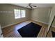 Bright bedroom with hardwood floors, a ceiling fan, and a large window at 830 44Th Ave. N # B4, Myrtle Beach, SC 29577