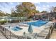 Community pool featuring a lounge area, tables with umbrellas, and a smaller pool at 830 44Th Ave. N # B4, Myrtle Beach, SC 29577