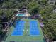 Aerial view showcasing two well-maintained tennis courts surrounded by lush greenery at 830 44Th Ave. N # B4, Myrtle Beach, SC 29577
