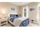 Charming bedroom with floral bedding, bedside table, and decorative art at 830 Howard Ave. # D, Myrtle Beach, SC 29577