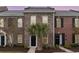 Charming brick townhome featuring a well-manicured lawn and a stylish black front door at 830 Howard Ave. # D, Myrtle Beach, SC 29577