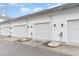 A row of attached white garages with black carriage lights, offering convenient parking at 830 Howard Ave. # D, Myrtle Beach, SC 29577