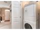 Convenient laundry area with a stacked washer and dryer next to an entry door at 830 Howard Ave. # D, Myrtle Beach, SC 29577