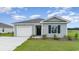 Charming single-story home with a manicured lawn, attached garage, and welcoming front entrance at 843 Buttonwood Dr., Conway, SC 29527