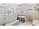 Bright bathroom featuring double sink vanity, soaking tub, and tiled glass door shower at 929 Tidewater Dr., North Myrtle Beach, SC 29582