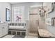 Bright bathroom showcasing soaking tub with tiled backsplash, and glass door shower at 929 Tidewater Dr., North Myrtle Beach, SC 29582