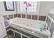 Close up view of white soaking tub with gray backsplash and chrome fixtures at 929 Tidewater Dr., North Myrtle Beach, SC 29582