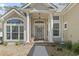 Home's entrance featuring a red door, front porch and lots of windows at 929 Tidewater Dr., North Myrtle Beach, SC 29582
