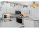 Well-lit kitchen with granite countertops, white cabinets, and modern appliances at 929 Tidewater Dr., North Myrtle Beach, SC 29582