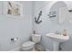 Stylish powder room with a pedestal sink, nautical decor, and updated fixtures at 929 Tidewater Dr., North Myrtle Beach, SC 29582
