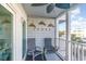 Charming outdoor balcony area with patio chairs and coastal decor and lighting at 9581 Shore Dr. # 223, Myrtle Beach, SC 29572