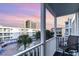 Balcony view overlooking a pool, palm trees, and neighboring condo buildings at sunset at 9581 Shore Dr. # 223, Myrtle Beach, SC 29572