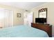 Cozy bedroom featuring a dresser with a television and comfortable blue quilt bedding at 9581 Shore Dr. # 223, Myrtle Beach, SC 29572