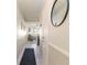 Hallway leading to the living area, featuring neutral tones, wainscoting, and a decorative mirror at 9581 Shore Dr. # 223, Myrtle Beach, SC 29572