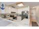 Bright kitchen featuring granite countertops, white cabinets, and modern appliances at 9581 Shore Dr. # 223, Myrtle Beach, SC 29572