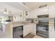 Bright kitchen features white cabinetry, granite countertops and black appliances at 9581 Shore Dr. # 223, Myrtle Beach, SC 29572