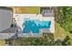 Aerial view of a large pool, pool house and lush backyard with mature trees at 976 South Marlin Circle, Murrells Inlet, SC 29576